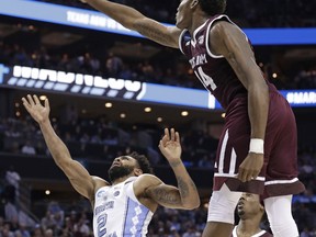 Texas A&M's Robert Williams (44) blocks a shot by North Carolina's Joel Berry II (2) during the second half of a second-round game in the NCAA men's college basketball tournament in Charlotte, N.C., Sunday, March 18, 2018.