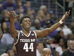 Texas A&M's Robert Williams (44) celebrates on the bench during the second half of a second-round game against North Carolina in the NCAA men's college basketball tournament in Charlotte, N.C., Sunday, March 18, 2018.