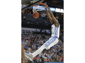 North Carolina's Theo Pinson (1) dunks against Lipscomb during the second half of a first-round game in the NCAA men's college basketball tournament in Charlotte, N.C., Friday, March 16, 2018.