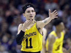 UMBC's K.J. Maura (11) celebrates after a basket against Virginia during the first half of a first-round game in the NCAA men's college basketball tournament in Charlotte, N.C., Friday, March 16, 2018.