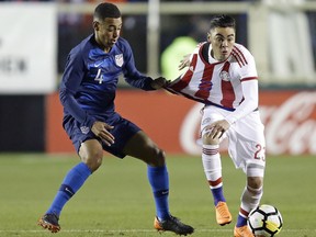 United States' Tyler Adams (4) and Paraguay's Miguel Almirón (23) chase the ball during the first half of an international friendly soccer match in Cary, N.C., Tuesday, March 27, 2018.