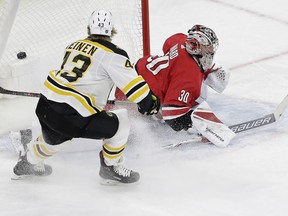 Boston Bruins' Danton Heinen (43) scores against Carolina Hurricanes goalie Cam Ward (30) during the third period of an NHL hockey game in Raleigh, N.C., Tuesday, March 13, 2018. Boston won 6-4.