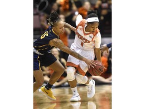 Mercer guard Sydni Means (1) and East Tennessee State guard Tianna Tarter (15) fight for control of the ball in the first half of an NCAA college basketball game for the Southern Conference tournament championship on Sunday, March 4, 2018 in Asheville, N.C.