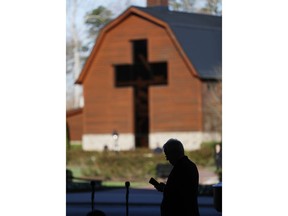 An usher reads a program ahead of a funeral service at the Billy Graham Library for the Rev. Billy Graham, who died last week at age 99, Friday, March 2, 2018, in Charlotte, N.C.