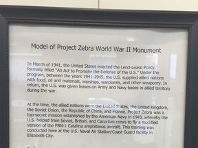 A framed description of "Project Zebra" hangs on the wall of the Arts of the Albemarle building in Elizabeth City, N.C., on Monday, March 12, 2018. The city council initially OK'd the Russian-financed monument commemorating the World War II operation, but a new council has declined to sign a memorandum of understanding that would allow the plan to proceed.