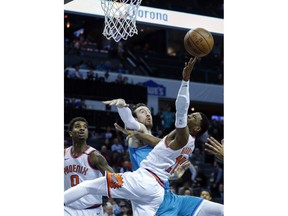 Phoenix Suns guard Shaquille Harrison, right, fights Charlotte Hornets forward Frank Kaminsky for the basketball in the first half of an NBA basketball game in Charlotte, N.C., on Saturday, March 10, 2018.