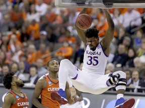 Kansas' Udoka Azubuike (35) dunks as Clemson's Gabe DeVoe, left, and Aamir Simms watch during the second half of a regional semifinal game in the NCAA men's college basketball tournament Friday, March 23, 2018, in Omaha, Neb. Kansas won 80-76.