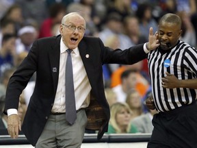 Syracuse head coach Jim Boeheim, left, accidentally hits an official while gesturing on the sideline during the first half of a regional semifinal game against Duke in the NCAA men's college basketball tournament Friday, March 23, 2018, in Omaha, Neb.