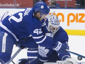 Maple Leafs goaltender Curtis McElhinney and Tyler Bozak combine to clear the puck away from Montreal Canadiens pressure during third period NHL action in Toronto on Saturday night.