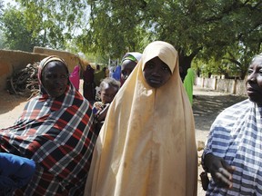 Falmata Abubakar, centre, one of the kidnapped girls from the Government Girls Science and Technical College Dapchi who was freed, is photographed after her release,  in Dapchi, Nigeria, Wednesday March. 21, 2018. Witnesses say Boko Haram militants have returned an unknown number of the 110 girls who were abducted from their Nigeria school a month ago.