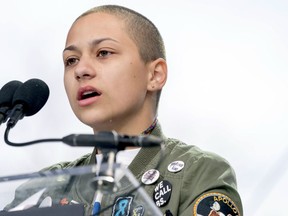 FILE -- In this March 24, 2018 file photo, Emma Gonzalez, a survivor of the mass shooting at Marjory Stoneman Douglas High School in Parkland, Fla., closes her eyes and cries as she stands silently at the podium for the amount of time it took the Parkland shooter to go on his killing spree during the "March for Our Lives" rally in support of gun control in Washington. A doctored photo online appeared to show Gonzalez tearing up the U.S. Constitution. , Saturday, March 24, 2018.