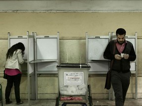 People vote inside polling station at a school in the Omraniyah district of Giza, Egypt Tuesday, March 27, 2018. Turnout appeared low as Egyptians voted on the second day of an election that President Abdel-Fattah el-Sissi is virtually certain to win, after all serious rivals were either arrested or intimidated into dropping out.