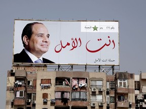 In this Monday, March 19, 2018 photo, an election banner for Egyptian President Abdel-Fattah el-Sissi hangs on top of a residential building with Arabic that reads, "you are the hope," on the ring road in Cairo, Egypt. Egyptians on social media are mocking the ubiquitous banners of el-Sissi raised ahead of this month's election. He faces no serious competition, but authorities are pushing for a large turnout to lend legitimacy to the vote. In photos and videos shared online, the banners have been inserted into the background of iconic scenes from movies and TV shows.