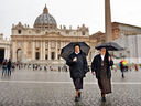 Nuns walk through St Peter's Square in Vatican City.