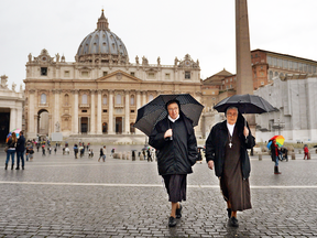 Nuns walk through St Peter's Square in Vatican City.