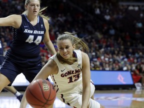 Gonzaga's Jill Barta (13) reaches for a loose ball covered by San Diego's Sydney Williams during the first half of the West Coast Conference tournament championship NCAA women's college basketball game Tuesday, March 6, 2018, in Las Vegas.