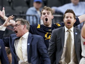 California's bench reacts to a call during the first half of an NCAA college basketball game against Stanford in the first round of the Pac-12 men's tournament Wednesday, March 7, 2018, in Las Vegas.