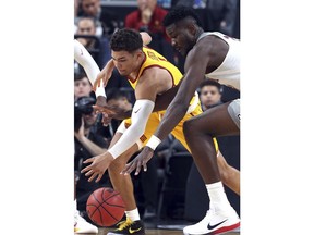 Arizona's Rawle Alkins, right, and Southern California's Jordan Usher reach for a loose ball during the first half of an NCAA college basketball game in the Pac-12 men's tournament final Saturday, March 10, 2018, in Las Vegas.