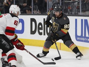 Vegas Golden Knights left wing Tomas Tatar (90) handles the puck in front of New Jersey Devils defenseman Andy Greene (6) during the second period of an NHL hockey game Wednesday, March 14, 2018, in Las Vegas.