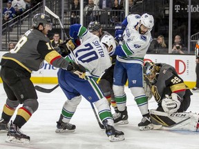 Vegas Golden Knights goaltender Marc-Andre Fleury (29) stops a shot by Vancouver Canucks center Brandon Sutter (20) during the first period of an NHL hockey game Tuesday, March 20, 2018, in Las Vegas.