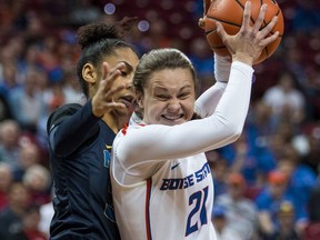 Nevada forward AJ Cephas, left, plays tight defense on Boise State guard Riley Lupfer, right,  as she drives the lane during the first half of an NCAA college basketball women's championship game in the Mountain West Conference tournament Friday, March 9, 2018, in Las Vegas.