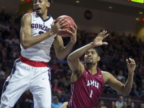 Gonzaga's Johnathan Williams (3) pulls down a rebound over Loyola Marymount's Zafir Williams (1) during the first half of an NCAA college basketball game in the quarterfinals of the West Coast Conference tournament, Saturday, March 3, 2018, in Las Vegas.