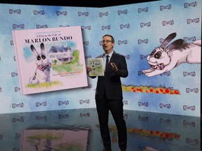 In this March 2018 photo provided by HBO, John Oliver holds the book "Last Week Tonight with John Oliver Presents a Day in the Life of Marlon Bundo".