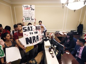 FILE- This Feb. 21, 2018 file photo shows students at the entrance to the office of Florida Gov. Rick Scott with boxes of petitions for gun control reform, at the state Capitol in Tallahassee, Fla.  Student survivors of the mass shooting in Florida who've organized to increase gun control and make schools safer aren't being bankrolled by billionaire liberal philanthropist George Soros, despite the claims of several false stories. Soros is not providing any funding to the students at Marjory Stoneman Douglas High School in Parkland although he does support their efforts, said his spokeswoman, Laura Silber.AP Photo/Gerald Herbert, File)