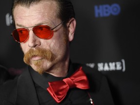 FILE - In this Feb. 2, 2017 file photo, Eagles of Death Metal band member Jesse Hughes arrives at the premiere of the HBO documentary film "Eagles of Death Metal: Nos Amis (Our Friends)," at the Avalon Hollywood  in Los Angeles.  Hughes, who survived a terrorist attack in Paris in 2015, says the Florida school shooting survivors who called for gun control during the March for Our Lives in Washington are "pathetic." In a series of Instagram posts over the weekend of March 25 ,2018, that were later deleted, Eagles of Death Metal frontman Jesse Hughes said the students were "exploiting" the deaths.