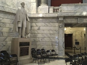 FILE - This July 20, 2017 file photo shows a statue of Jefferson Davis in the Kentucky Capitol in Frankfort, Ky.  State officials are set to give an update on plans to remove a plaque from a statue of Jefferson Davis declaring him to be a patriot and a hero, Thursday, March 29, 2018. A commission that oversees the statue has voted to remove the plaque, but legal questions have delayed the action.