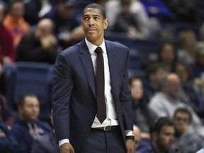 FILE - In this Dec. 9, 2017 file photo, Connecticut head coach Kevin Ollie looks up at the scoreboard during the first half of an NCAA college basketball game against Coppin State in Storrs, Conn. UConn has fired Ollie, with the team under NCAA investigation and the Huskies having completed their second straight losing season. The university said in a statement Saturday, March 10, 2018,  it has "initiated disciplinary procedures" to dismiss him for "just cause." The school says it would have no further comment until its "disciplinary process" and the ongoing NCAA inquiry are complete.