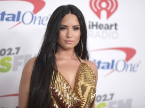FILE - In this Dec. 1, 2017 file photo, Demi Lovato arrives at Jingle Ball at The Forum in Inglewood, Calif.  Lovato celebrated six years sober at a concert in New York with tour mate and DJ Khaled, whose powerful brought the pop star to tears. Lovato performed Friday, March 16, 2018  at the Barclays Center in Brooklyn, New York, telling the audience March 15 was a proud day for her.