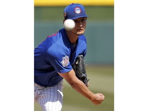 FILE - In this March 6, 2018, file photo, Chicago Cubs pitcher Yu Darvish throws during the first inning of a spring training baseball game against the Los Angeles Dodgers in Mesa, Ariz. Darvish reportedly was tipping his pitches in the World Series, playing a role in two costly losses. The Japanese right-hander finalized a $126 million, six-year deal with the Cubs last month, but no one on his new team seems all that concerned.