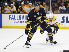 FILE - In this March 19, 2018, file photo, Buffalo Sabres' Jack Eichel (15) carries the puck past Nashville Predators' Mike Fisher (12) during the third period of an NHL hockey game in Buffalo, N.Y. Eichel has difficulty assessing the sorry state of the Sabres, who haven't had a sniff at the playoffs in the three years since his celebrated arrival. "When I got drafted, if you would've said we'd be in this position, I probably would've told you to give your head a shake," Eichel told The Associated Press.