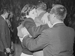 FILE - In this March 23, 1963, file photo, Kathy Ireland gives her father, Loyola coach George Ireland, a hug after they defeated Cincinnati 60-58 in overtime in the National Collegiate basketball finals in Louisville, Ky. The Ramblers play Nevada on Thursday, March 22, 2018, after two thrilling wins to reach the Sweet 16, earning more wins this season than the team that won the 1963 title.