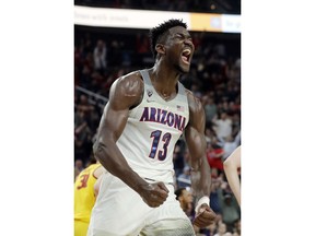 FILE - In this March 10, 2018, file photo, Arizona's Deandre Ayton reacts after a dunk against Southern California during the second half of an NCAA college basketball game for the Pac-12 men's tournament championship, in Las Vegas. Ayton is a member of the Associated Press NCAA college basketball All-America first team, announced Tuesday, March 27, 2018.