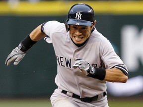 FILE - In this July 23, 2012, file photo, New York Yankees' Ichiro Suzuki races to third against the Seattle Mariners in the fourth inning of a baseball game in Seattle. The Mariners finalized a one-year deal with 44-year-old Japanese star on Wednesday, March 7, 2018, after several outfielders got hurt.