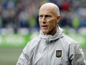 FILE - In this March 4, 2018, file photo, Los Angeles head coach Bob Bradley walks on the pitch before an MLS soccer match against the Seattle Sounders in Seattle. Six coaches begin their first full MLS season with a new team, a league record. Most notable is Bradley, who won his debut with LAFC.