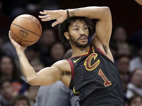 FILE - Int this Jan. 20, 2018, file photo, Cleveland Cavaliers' Derrick Rose (1) passes during the second half of an NBA basketball game against the against the Oklahoma City Thunder in Cleveland. A person familiar with the situation said Thursday, March 8, 2018, that Rose has agreed to sign with the Minnesota Timberwolves for the remainder of the season. Cleveland traded Rose to Utah, and the Jazz waived him before he played there.
