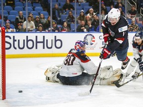 FILE - In this Dec. 28, 2017, file photo, United States' Casey Mittelstadt scores a goal on Slovakia goalie Roman Durny, left, as Michal Ivan, right, defends during the third period of an IIHF world junior hockey championships game in Buffalo, N.Y. The Buffalo Sabres have reached an agreement with their top prospect, center Casey Mittelstadt, who is leaving Minnesota following his freshman season. Mittelstadt agreed to a three-year entry level contract Monday, March 26, 2018, and is expected to join the Sabres as early as Tuesday.