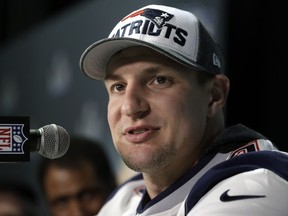 FILE - In this Feb. 4, 2018, file photo, New England Patriots tight end Rob Gronkowski answers questions during a news conference ahead of the Super Bowl, in Minneapolis.  Police have arrested a second suspect in connection with a burglary at Gronkowski's Massachusetts home while he was at the Super Bowl. Authorities say 28-year-old Eric Tyrell, who was wanted on two counts of receiving stolen property, turned himself in Tuesday, March 27, 2018.
