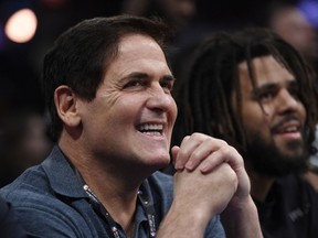 FILE - In this Saturday, Feb. 17, 2018 file photo, Dallas Mavericks owner Mark Cuban watches from the crowd during NBA All-Star Saturday in Los Angeles. When the Dallas owner went on Hall of Famer Julius Erving's podcast in February and said he told his players that "losing is our best option," the league fined him $600,000 for "public statements detrimental to the NBA." That put a spotlight on the Mavericks. So if they were planning on packing it in and trying to add more young legs in the draft for Nowitzki's expected swan song, suddenly they had to change plans.
