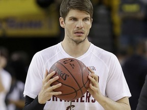 FILE - In this June 12, 2017, file photo, Cleveland Cavaliers guard Kyle Korver warms up before Game 5 of basketball's NBA Finals between the Golden State Warriors and the Cavaliers, in Oakland, Calif. Kyle Korver joined his two remaining brothers in comforting their parents during a funeral for their youngest brother, Monday, March 26, 2018, in Pella, Iowa. Twenty-seven-year-old Kirk Korver died March 20 of a sudden illness.