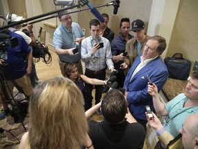 New England Patriots head football coach Bill Belichick, right, answers a question from a reporter at the coaches breakfast during the NFL owners meetings, Tuesday, March 27, 2018 in Orlando, Fla.