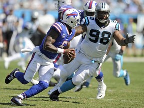 FILE - In this Sept. 17, 2017, file photo, Buffalo Bills' Tyrod Taylor (5) scrambles under pressure from Carolina Panthers' Star Lotulelei (98) in the second half of an NFL football game, in Charlotte, N.C. A person familiar with the situation confirms to The Associated Press that free agent defensive tackle Star Lotulelei has reached an agreement to sign a five-year contract with the Buffalo Bills. The person spoke on the condition of anonymity because the signing won't become official until the NFL's business year opens on Wednesday, March 14, 2018.