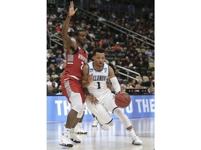 FILE - In this Thursday, March 15, 2018, file photo, Villanova's Jalen Brunson (1) drives on Radford's Ed Polite Jr. during the second half of an NCAA men's college basketball tournament first-round game in Pittsburgh. Villanova takes on West Virginia in a regional semifinal on Friday.