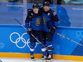 FILE - In this Feb. 16, 2018, file photo, Eeli Tolvanen, of Finland, left, celebrates a goal with Sami Lepisto (18) during the second period of the preliminary round of the men's hockey game against Norway at the 2018 Winter Olympics in Gangneung, South Korea.  The Nashville Predators have signed forward Eeli Tolvanen of Finland, the 30th pick overall last year, to an entry-level contract, adding the talented 18-year-old to a roster already sitting atop the NHL. General manager David Poile announced Thursday, March 29, 2018, that the immigration and other paperwork had been completed with Tolvanen agent Jay Grossman in Nashville to finalize the last details.