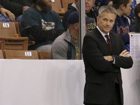 FILE - In this March 25, 2017, file photo, Minnesota head coach Don Lucia looks on from the bench before the start of an NCAA regional men's college hockey tournament game against Notre Dame, in Manchester, N.H. Longtime Minnesota hockey coach Don Lucia is stepping down after a disappointing year that ended with the Gophers missing the NCAA Tournament. The university announced Lucia's departure in a statement Tuesday, March 20, 2018.