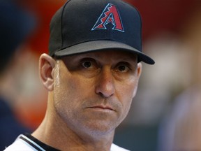 FILE - In this June 9, 2017, file photo, Arizona Diamondbacks' Torey Lovullo pauses in the dugout prior to a baseball game against the Milwaukee Brewers, in Phoenix. The Diamondbacks were one of baseball's big surprises a year ago. The surprise this year would be if they don't keep winning. ``Last year we kind of snuck up on people and had to earn their respect,'' said Lovullo, the National League manager of the year in his first season in the desert.