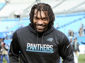 FILE - In this Dec. 17, 2017, file photo, Carolina Panthers defensive end Julius Peppers walks onto the field prior to an NFL football game between the Carolina Panthers and the Green Bay Packers, in Charlotte, N.C. The Panthers have announced they have re-signed free agent defensive end Julius Peppers to a one-year contract. A person familiar with the situation says the deal is for $5 million, with $2.5 million guaranteed. The person spoke to The Associated Press on Wednesday, March 14, 2018,  on condition of anonymity because the team does not release financial terms of contracts.